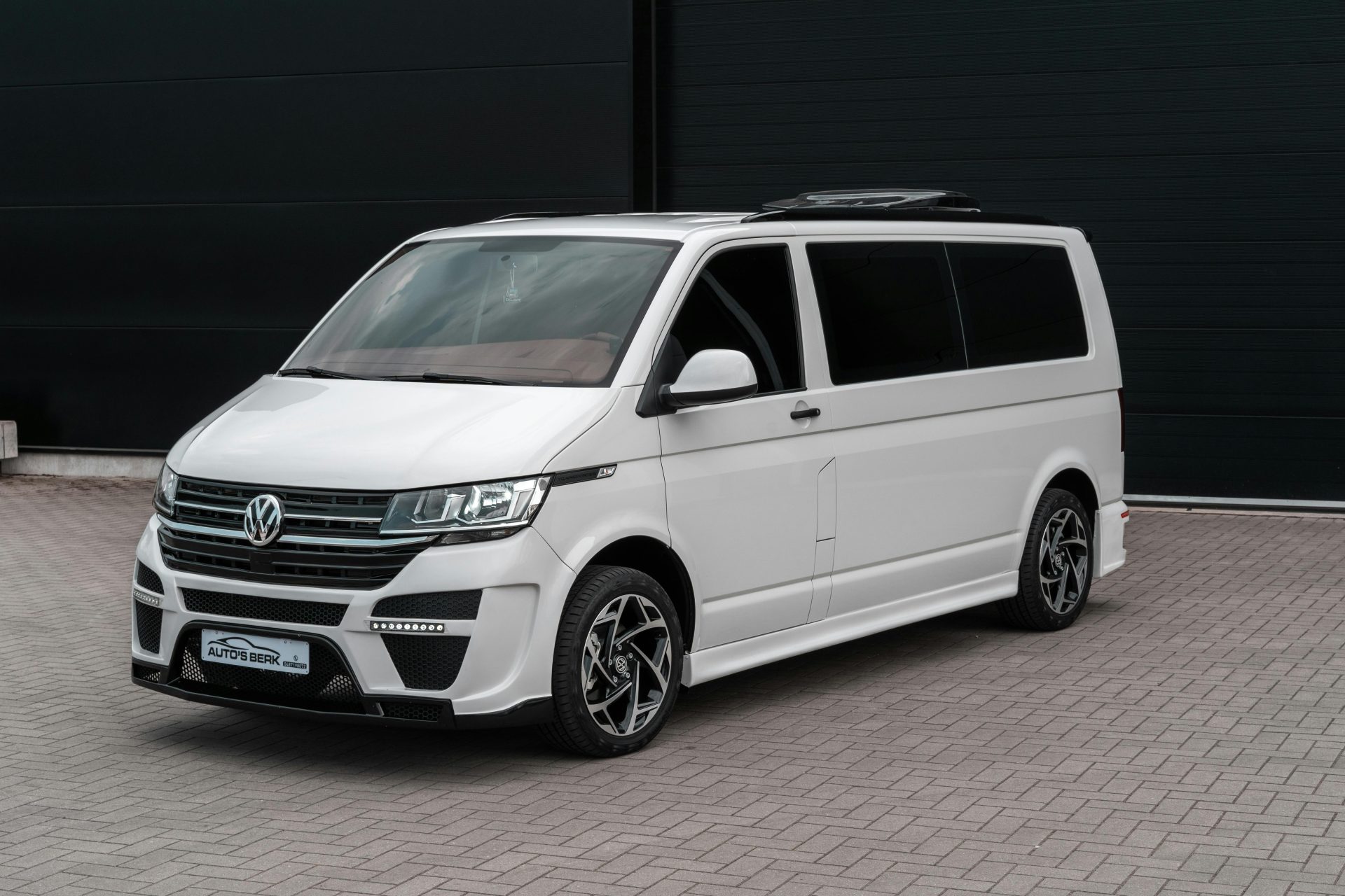 A modern Volkswagen van parked outdoors, showcasing urban style and design.